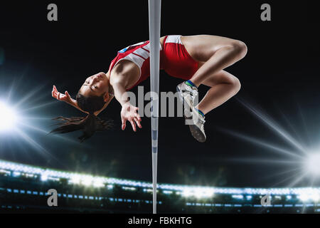 Japanese female high jump athlete jumping Stock Photo