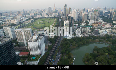 A aerial drone view over Lumpini Park and The Royal Bangkok Horse Racecourse in Bangkok, Thailand looking north. The BTS Silom l Stock Photo