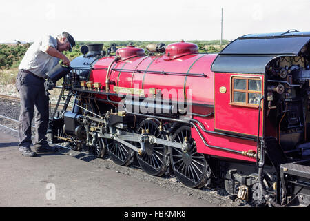 England, Kent, Dungeness. The driver tops up the oil levels in the miniature steam locomotive, 'Winston Churchill'. Stock Photo