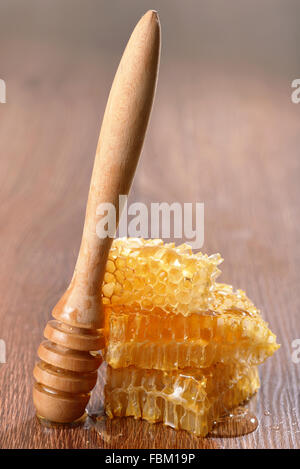 honeycombs and drizzler on wooden background Stock Photo