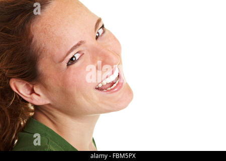 Happy young smiling woman looking sideways into the camera Stock Photo