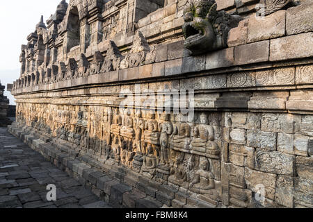 Relief panels of Borobudur temple in Indonesia. Borobudur is the largest Buddhist temple in the world. Stock Photo