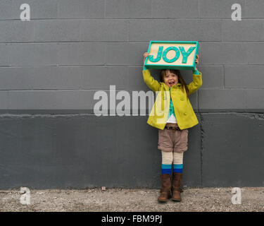Happy girl holding a joy sign Stock Photo
