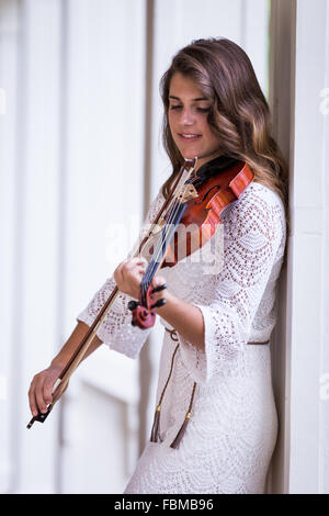 Teenage girl Playing a violin Stock Photo