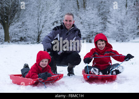 Andy Cooper, 39, (C) and his two sons Ted Cooper, 7, (L) and Charlie Cooper, 4, (R) enjoy the snowy conditions in Otley. Stock Photo