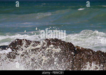 Waves crashing onto rocks at Bloubergstrand, Cape Town, Western Cape Province, South Africa. Stock Photo
