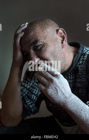 Man covered in paint  smoking cigarette Stock Photo