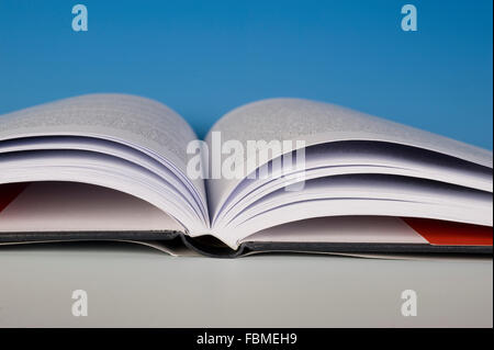 Open book spine resting on a table. Stock Photo