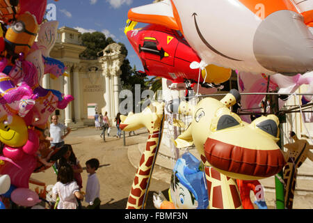 Balloon sellers and tourists at the entrance to the Giardino Zoologico or Zoological Gardens, Villa Borghese, Rome, Italy. Stock Photo