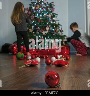 Boy and girl decorating Christmas tree Stock Photo