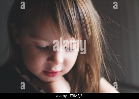 Portrait of a girl looking down Stock Photo