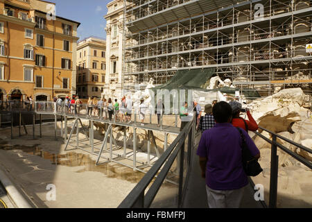 Tourists on a temporary walkway at the drained Trevi fountain, Rome, Italy during its restoration. Stock Photo
