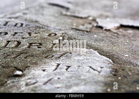 Lettering on a broken gravestone in Bristol on a winter's morning Stock Photo