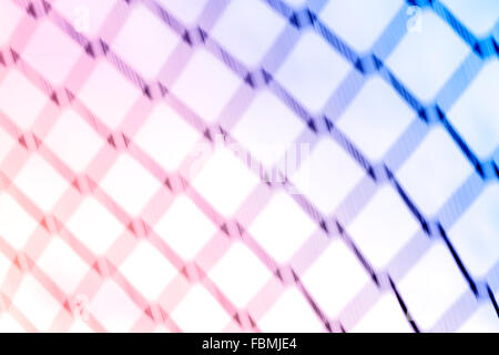 Abstract background made of motion blurred fence net. Stock Photo