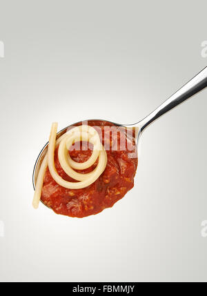 Spaghetti and bolognese sauce on a spoon Stock Photo