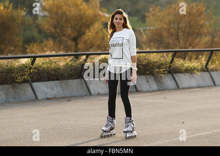 A caucasian young woman practicing inline skating in Santander, Cantabria, Spain. Stock Photo
