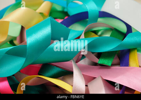 Multi-colored satin ribbons in a chaotic manner closeup Stock Photo