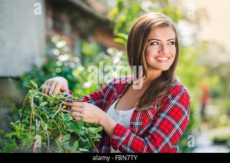 Beautiful young woman gardening Stock Photo