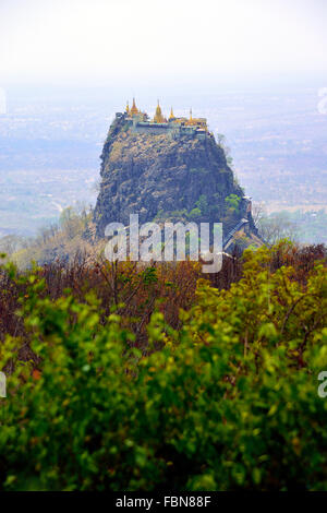 Mount Popa and the Popa Taungkalat monastery, inland near Bagan (Burma) ,Myanmar perched dramatically atop a huge rocky outcrop. Stock Photo