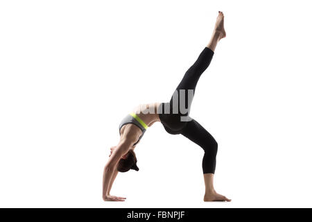 Sporty beautiful young brunette woman in sportswear bra and black pants working out, One-legged Upward Bow (Wheel) Pose Stock Photo