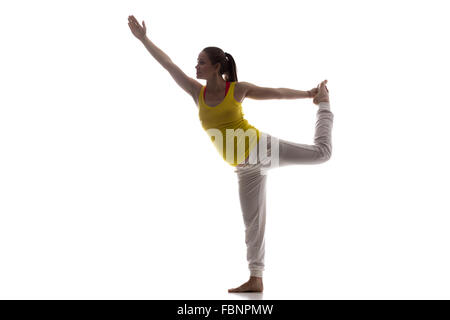Full length silhouette of young pregnant fitness model in sportswear doing yoga, pilates training, backbend Stock Photo