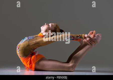 Beautiful gymnast athlete teenage girl wearing dancer colorful leotard working out, dancing, posing, doing backbend, athletic Stock Photo