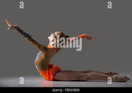 Beautiful gymnast athlete teenage girl wearing dancer colorful leotard working out, dancing, posing, doing backbend, gymnastics Stock Photo