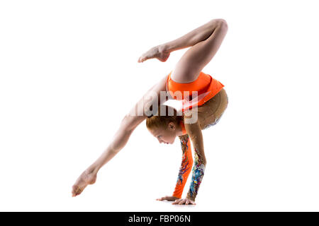 Beautiful gymnast athlete teenage girl wearing dancer colorful leotard working out, dancing, doing backbend, handstand exercise Stock Photo