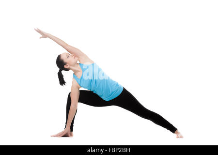 Yoga girl on white background exercises in yoga posture Utthita Parsva Konasana (Extended Side Angle Pose) Stock Photo