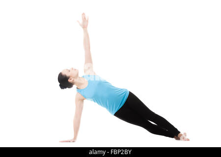 Sporty yogi girl doing exercises, Side Plank Pose, Vasisthasana, Yoga Pose, isolated on white background Stock Photo