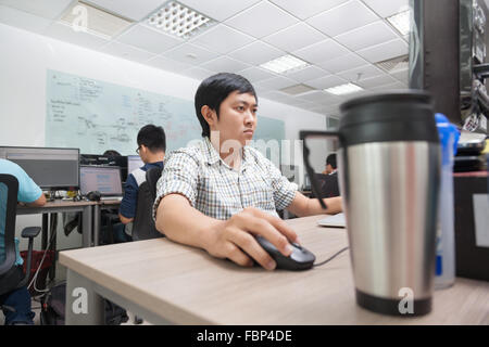Asian Developer Using Laptop Computer Sitting Working Stock Photo