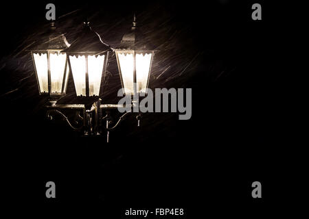 Street lamps in snowfall close up photo. Night. Stock Photo