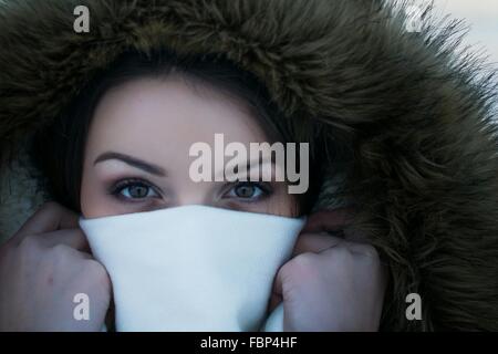 Close-Up Portrait Of Young Woman Covering Face With Napkin