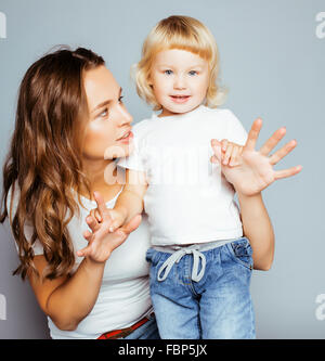 pretty real fashion mother with cute blond little daughter close up smiling happy Stock Photo