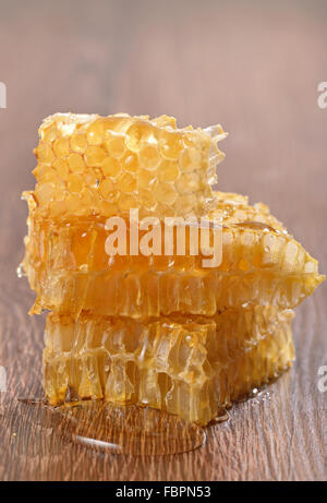 honeycombs with honey on wooden background Stock Photo