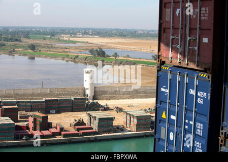 View from container ship of building materials on construction site alongside the waterway of the Suez Canal Stock Photo