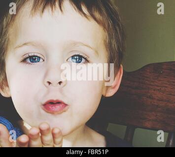 Portrait Of Cute Blue Eyed Boy Blowing A Kiss
