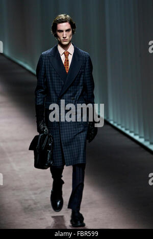 Milan, Italy. 18th Jan, 2016. A model relaxes himself with a cellphone ...