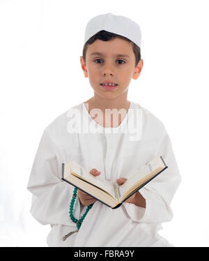 Muslim young kid reading Quran Stock Photo