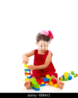 funny child girl playing with construction set over white background Stock Photo