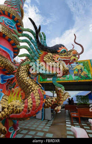 A dragon statue is a pillar in front of Chinese temple. Stock Photo