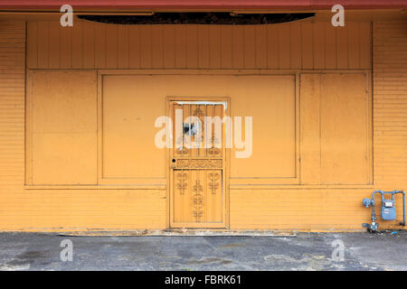 Old door and wall in a closed up store. Stock Photo