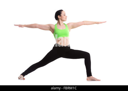 Sporty girl on white background doing lunge exercise, Warrior II posture, Virabhadrasana 2 Stock Photo