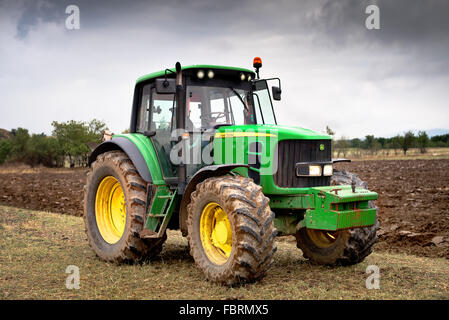 Karlovo, Bulgaria - August 22th, 2015: Ploughing a field with John Deere 6930 tractor. John Deere 8100 was manufactured in 1995- Stock Photo