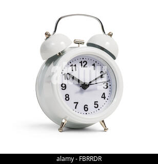 Classical alarm clock stands on the white background Stock Photo