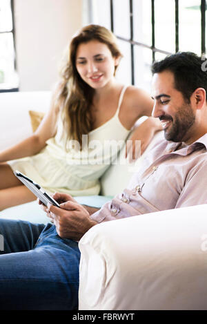 Couple using digital tablet at home Stock Photo