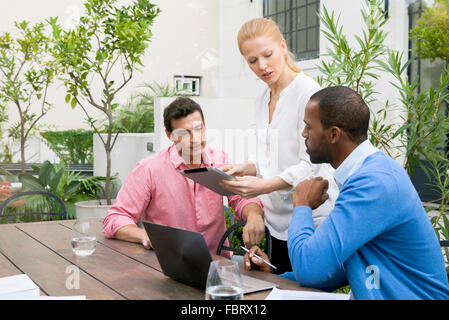 Businesswoman presenting idea at team meeting Stock Photo