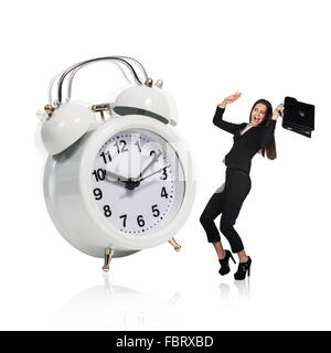 Business woman stand near big alarm clock Stock Photo