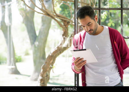 Man using digital tablet at home Stock Photo