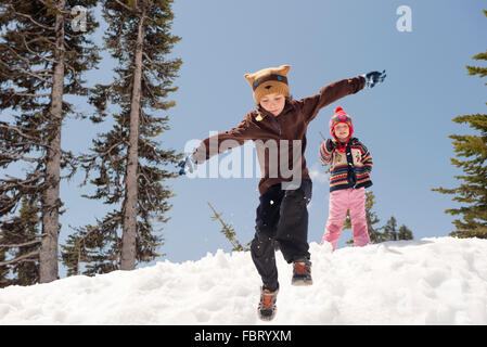 Boy jumping in snow Stock Photo